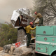 Firefighters wrap a historic Sequoia National Park sign in protective foil.